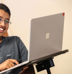SMSSP student in front of computer